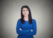 Closeup portrait grumpy annoyed, sad, unhappy, dissatisfied young woman, wife, employee, customer, isolated grey wall background. Human face expressions, emotions, reaction, attitude, perception